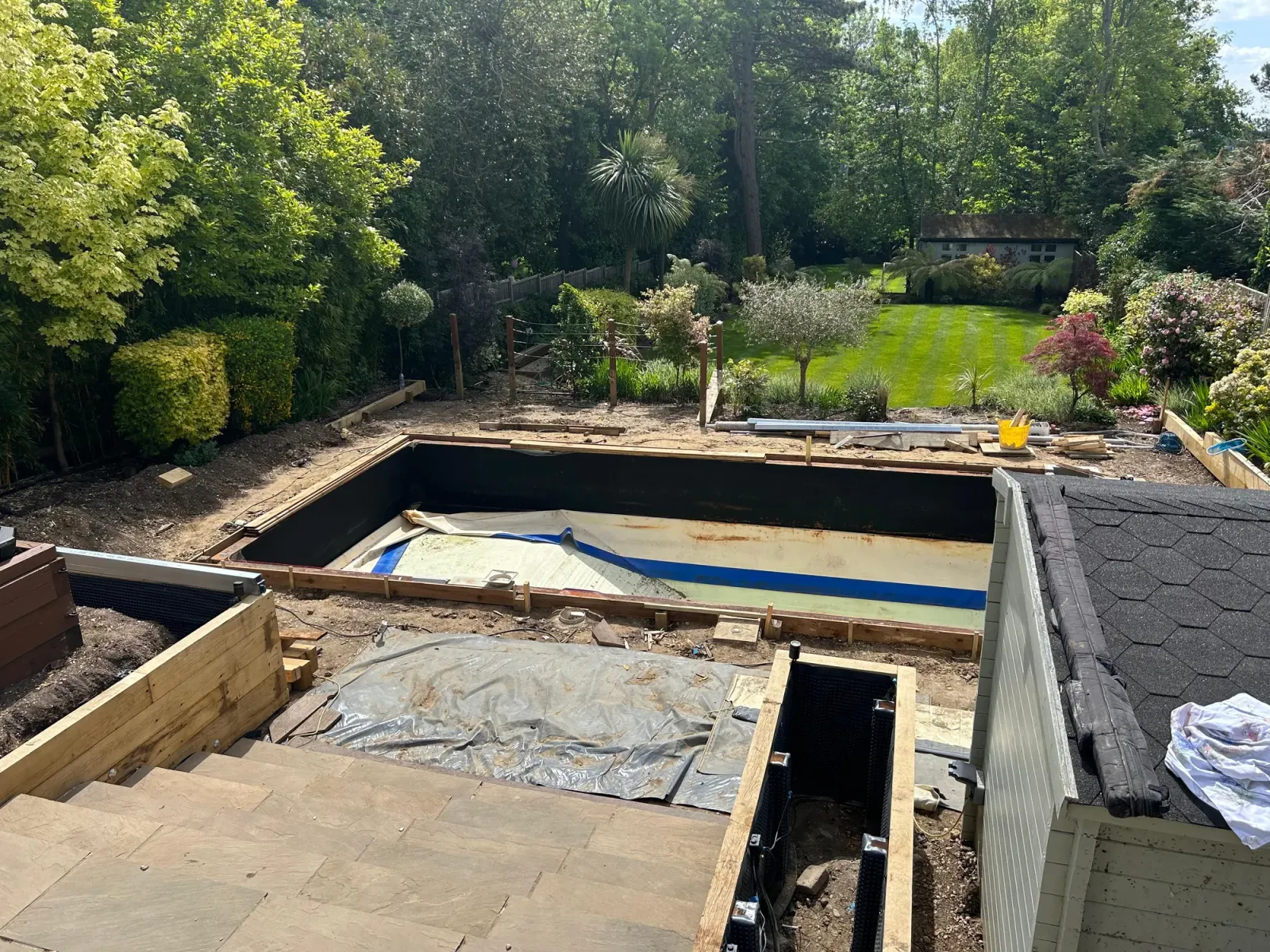 Composite decking installation in progress around a pool
