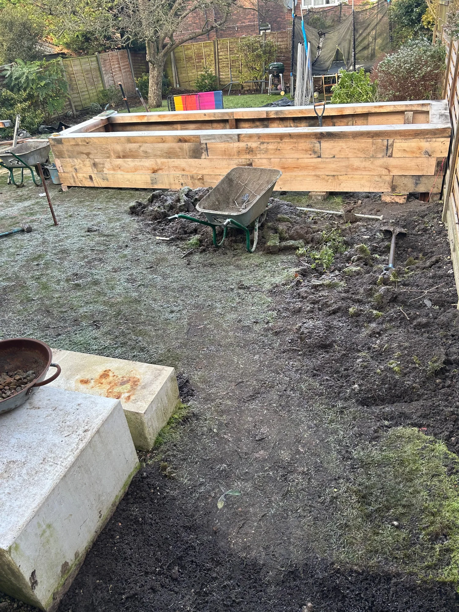 Composite decking layout with sleeper-edged raised flower beds