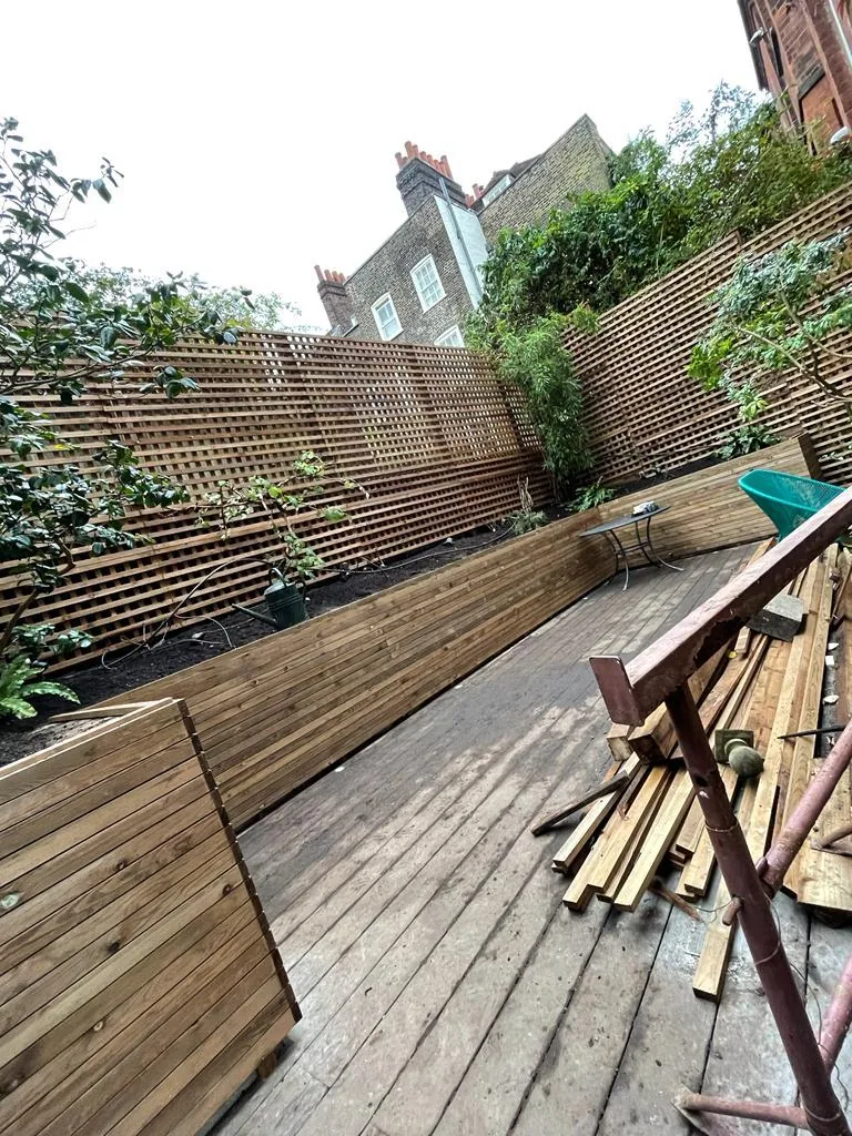 Cladding and slatted trellis install partway through