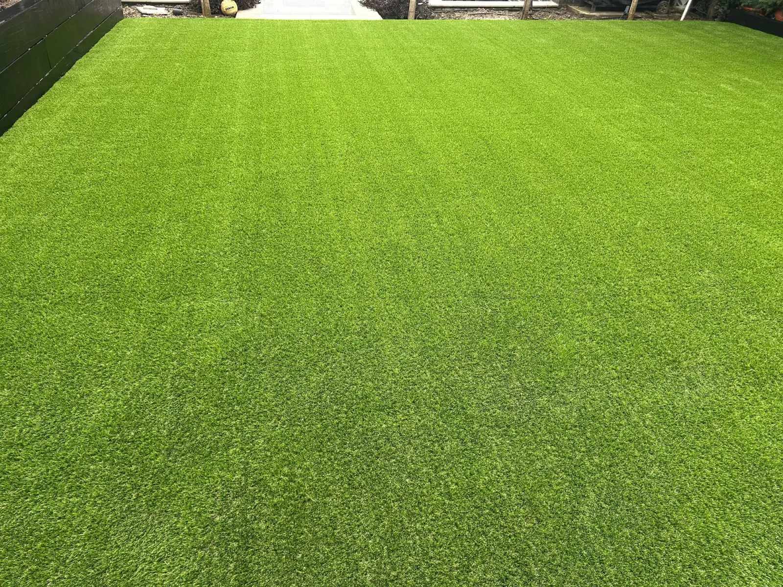 Lush green artificial turf installation, finished