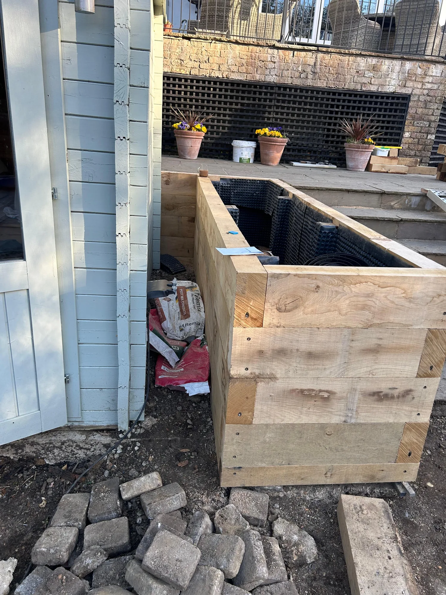 Railway sleeper raised flower beds, freshly built and ready for planting