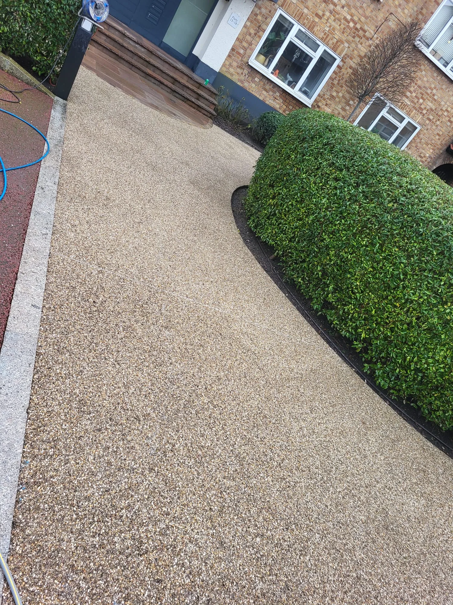 Half-cleaned patio showing before / after of pressure washing