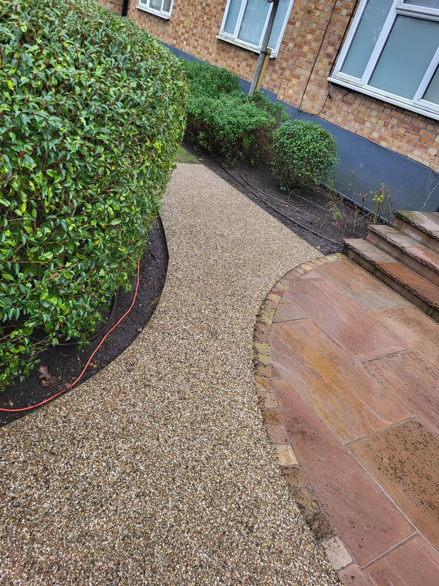 Tired patio surface being restored by pressure washing