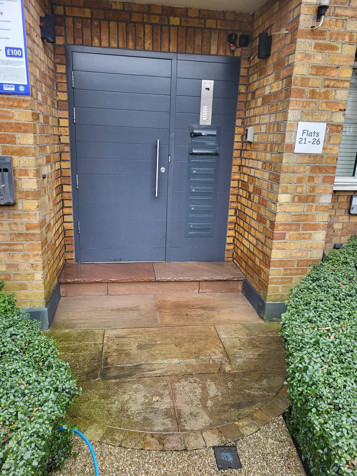 Lifting moss and grime from paving joints with a pressure washer