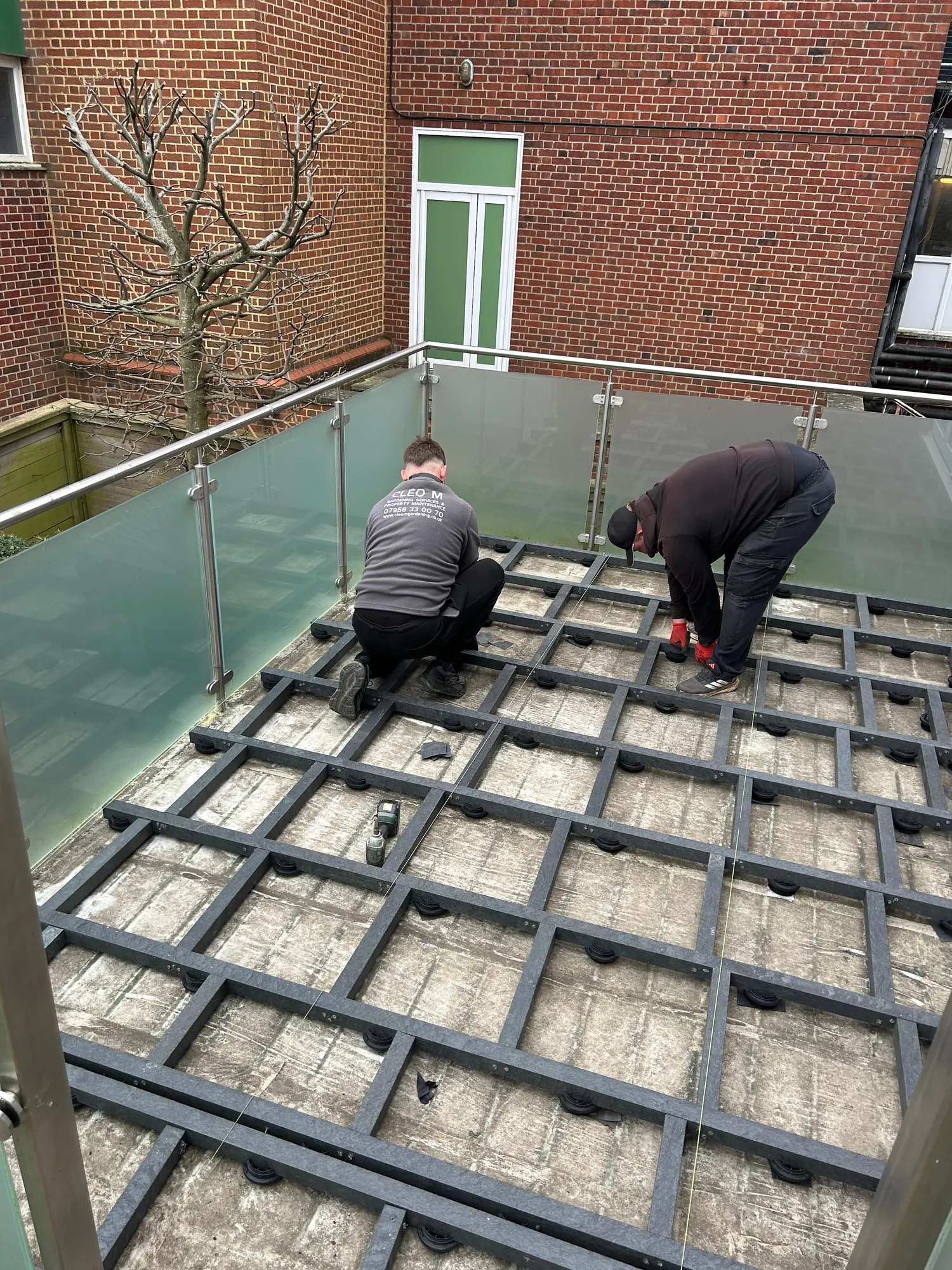 During: laying the new composite boards onto the cleaned joist sub-frame